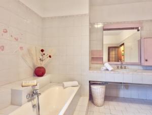 a white bathroom with a tub and a sink at Dimora Concept - Ca' du Dria - Sea and nature - Free parking in Pietra Ligure +23 photos