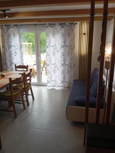 a living room with a blue couch and a table at Domek letniskowy in Klusek Biały