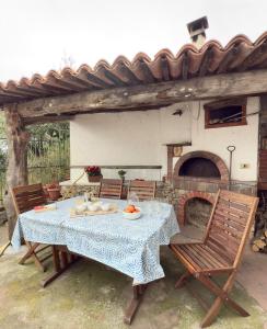 a table and chairs with a table and a fireplace at Dimora Concept - Ca' du Dria - Sea and nature - Free parking in Pietra Ligure