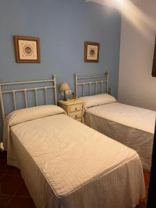 a bedroom with two beds and a table with a lamp at Casa Martijo in Taramay +40 photos