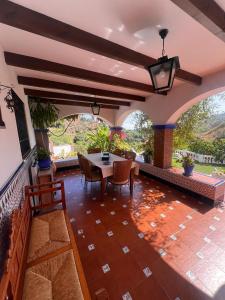 a dining room with a table and chairs on a patio at Casa Martijo in Taramay