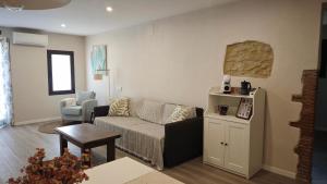 a living room with a couch and a table at Can Costals Lavanda in Pals