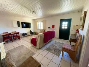 a living room with a couch and a table at Casa da Laranjeira Pet Friendly in Vale Covo