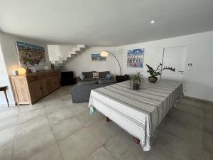 a living room with a bed and a couch at La Villa des Lauriers in La Flotte