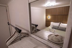 a mirror in a room with a bed and a couch at Nonna Konstantina- old town center in Lefkada