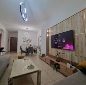 a living room with a television on a wall at beautiful apartment in tanger beach in Hauara