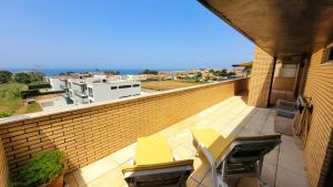 a balcony with tables and chairs on a brick wall at Casa da Praia in Vila Nova de Gaia