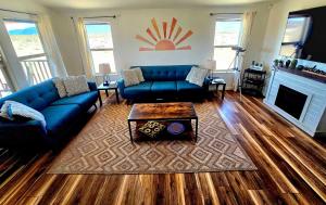 a living room with a blue couch and a fireplace at Indian Cove in Twentynine Palms