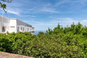 a white building with the ocean in the background at Hotel Bellavista in Anacapri