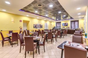 a dining room filled with tables and chairs at Hotel Ottaviano Augusto in Rome