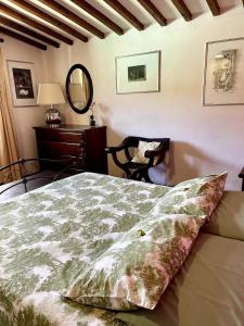 a bedroom with a bed and a table and a mirror at VillAmato Casa Vacanze ULIVO in Arezzo +22 photos