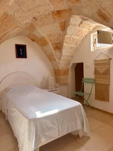 a bedroom with a bed and a stone ceiling at Dimora Orsini del Balzo in Carovigno