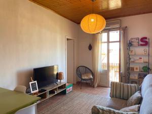 a living room with a couch and a flat screen tv at El Racó de Baix in Seva