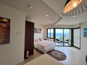 a bedroom with a bed and a view of the ocean at Room in Maribago in Lapu Lapu City +4 photos