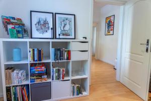 a white book shelf filled with books at CityFlair in Rostock