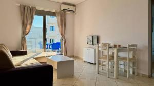 a living room with a couch and a table at Ama Saranda Apartment in Sarandë +23 photos