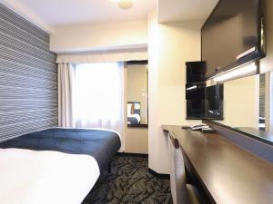 a hotel room with a bed and a television at APA Hotel Akihabara Ekimae in Tokyo