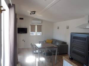 a living room with a table and a couch at Chalet du Chesnot , Aucey-la-Plaine in Aucey-la-Plaine