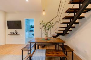 a living room with a wooden table and stairs at Céntrico y amplio apartamento in Seville