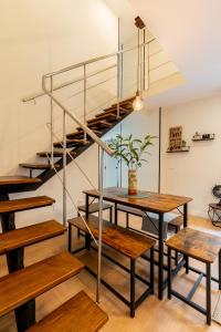 a room with wooden tables and a spiral staircase at Céntrico y amplio apartamento in Seville
