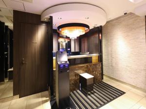 a lobby with a elevator and a door with a counter at APA Hotel Akihabara Ekimae in Tokyo