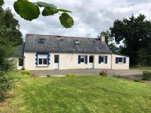a white house with blue windows and a yard at Ty Amani - Breton Family Getaway in Plourivo +10 photos