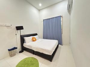 a bedroom with a bed with a teddy bear on it at Comfort 36 Entire House At Alma Bukit Mertajam in Bukit Mertajam
