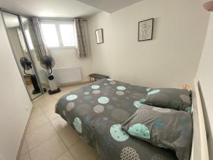 a small bedroom with a bed and a window at Gite Thym spa au coeur d'une oliveraie des Corbières in Saint-Jean-de-Barrou +10 photos