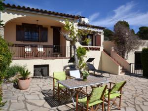 a patio with a table and chairs in front of a house at Casa a Solric con piscina compartida, 3 habitaciones, cerca de L'Estartit y playas - ES-323-40 in L'Estartit
