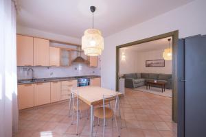 a kitchen and dining room with a table and chairs at House Levante 28 APT 1 in Pula