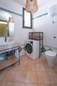 a bathroom with a washing machine and a toilet at House Levante 28 APT 1 in Pula +52 photos