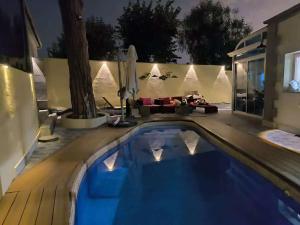 a swimming pool in a backyard at night at Can cruspinera With 6 Bedroom in Tiana