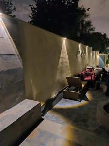 a concrete wall with a row of tables and chairs at Can cruspinera With 6 Bedroom in Tiana
