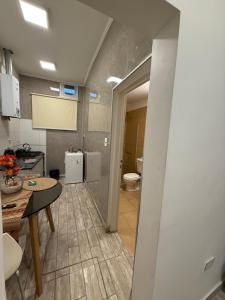 a kitchen with a sink and a toilet in a room at Departamento en vicente López … sentite en tu casa in Florida