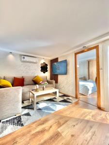 a living room with a couch and a table at Villa 2, Modern Charm Facing Carrousel with Ocean View in Rabat