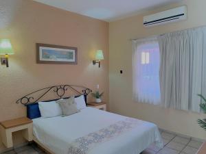 Postel nebo postele na pokoji v ubytování Estancia Real Los Cabos