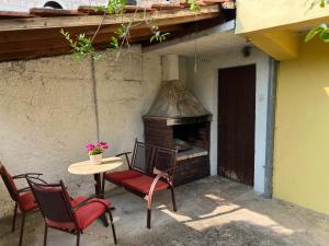 a patio with a table and chairs and an outdoor oven at Apartment Stolac in Stolac