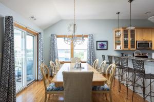 a dining room with a table and chairs at Steps to Beach Pool Game Room Aug Weeks Open in Corolla
