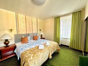 a hotel room with a bed and a window at Parkhotel Sonne in Schönau im Schwarzwald