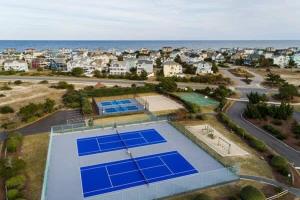 an aerial view of a tennis court with blue tennis at Steps to Beach Pool Game Room Aug Weeks Open in Corolla