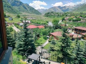 a view of a village with mountains in the background at Vardisubani Villa in Kazbegi +68 photos
