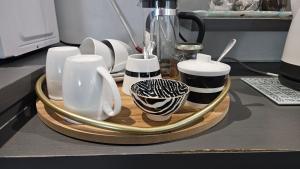 a tray with plates and cups on a counter at Lily's Rest, Village on Silwerstrand, Robertson in Robertson +20 photos