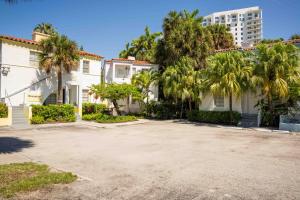a house with palm trees and a building at Miami River Inn by Renzzi in Miami