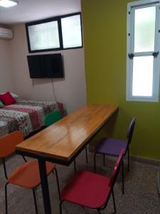 a room with a table and chairs and a bed at El Departamentito in Villa Mercedes