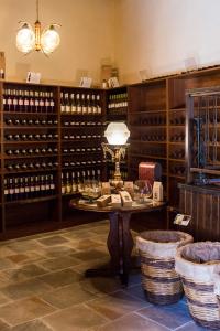 a wine tasting room with a table and wine bottles at Stou Kir Yianni in Omodos