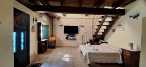 a large room with a bed and a tv in it at La Rondine in Villamassargia +7 photos