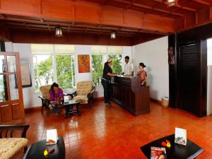 a group of people standing around a kitchen in a room at Blackberry Hills Munnar- Nature Resort & Spa in Munnar