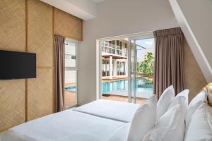 a bedroom with a bed and a swimming pool at Asaya Sands Mirissa in Mirissa