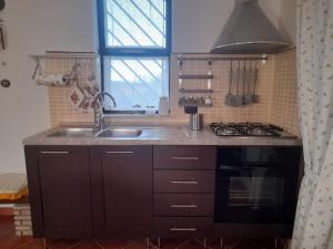 a kitchen with a sink and a stove at Villa Rosa in Andria