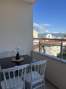 a table and chairs on a balcony with a view at Hotel Palace Struga in Struga
